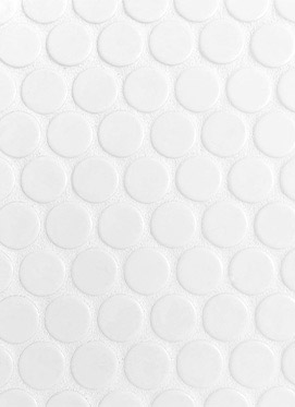 A closeup image of white penny tile used on the kitchen counter backsplash